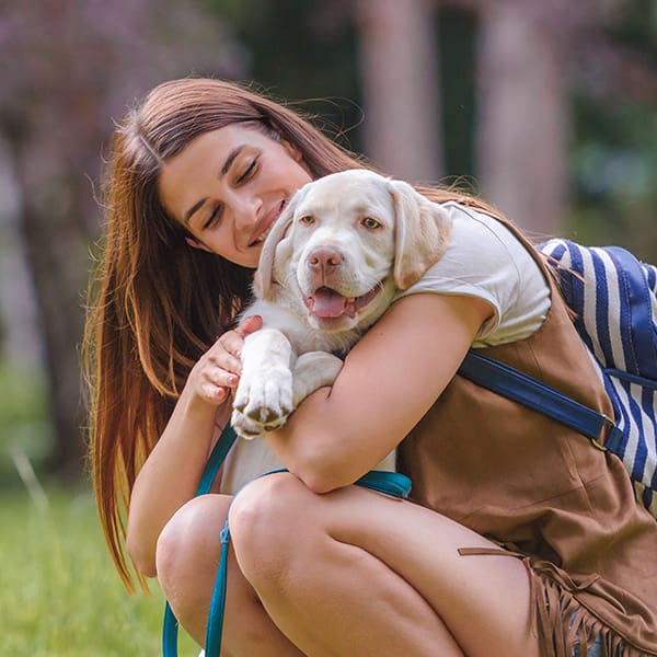 Woman Hugging Puppy Outside